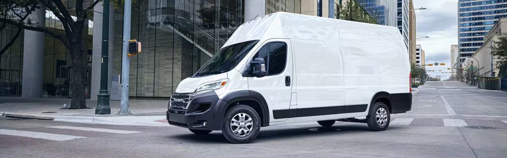 2026 Ram Promaster van moving in a street, showing its reliability, space, and capability.